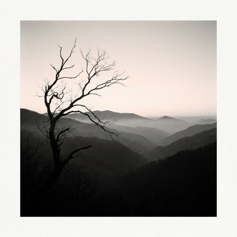 Foggy mountain valley at dawn, layered ridgelines